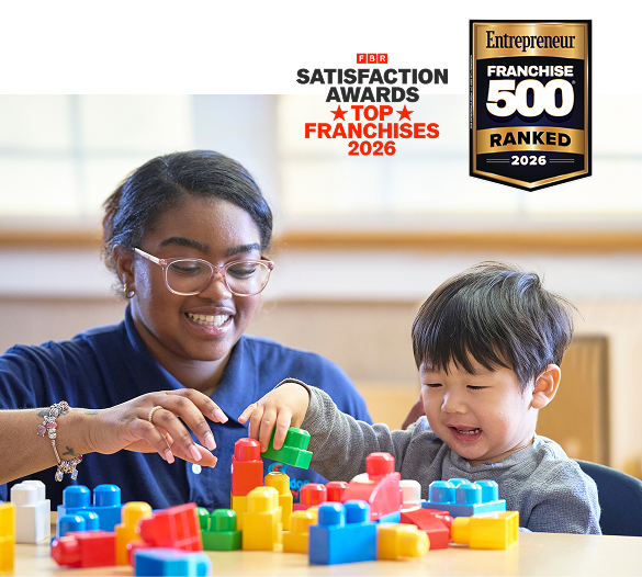Image of a teacher and a child playing with blocks